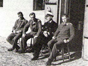 Vier Duitse geïnterneerden voor een van de buitendeuren van Fort bij Spijkerboor.