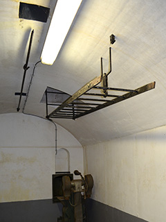 Een binnenopname met de ladder naar de observatiekoepel opgehangen en vastgeklikt op fort Kudelstaart.