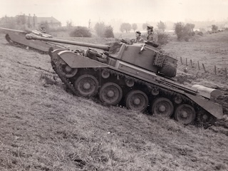 Een Comet probeert de dijkhelling te beklimmen.
